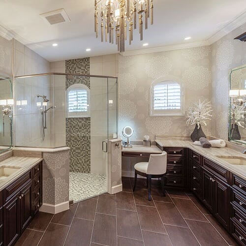 remodeled bathroom with dark cabinets and chandelier