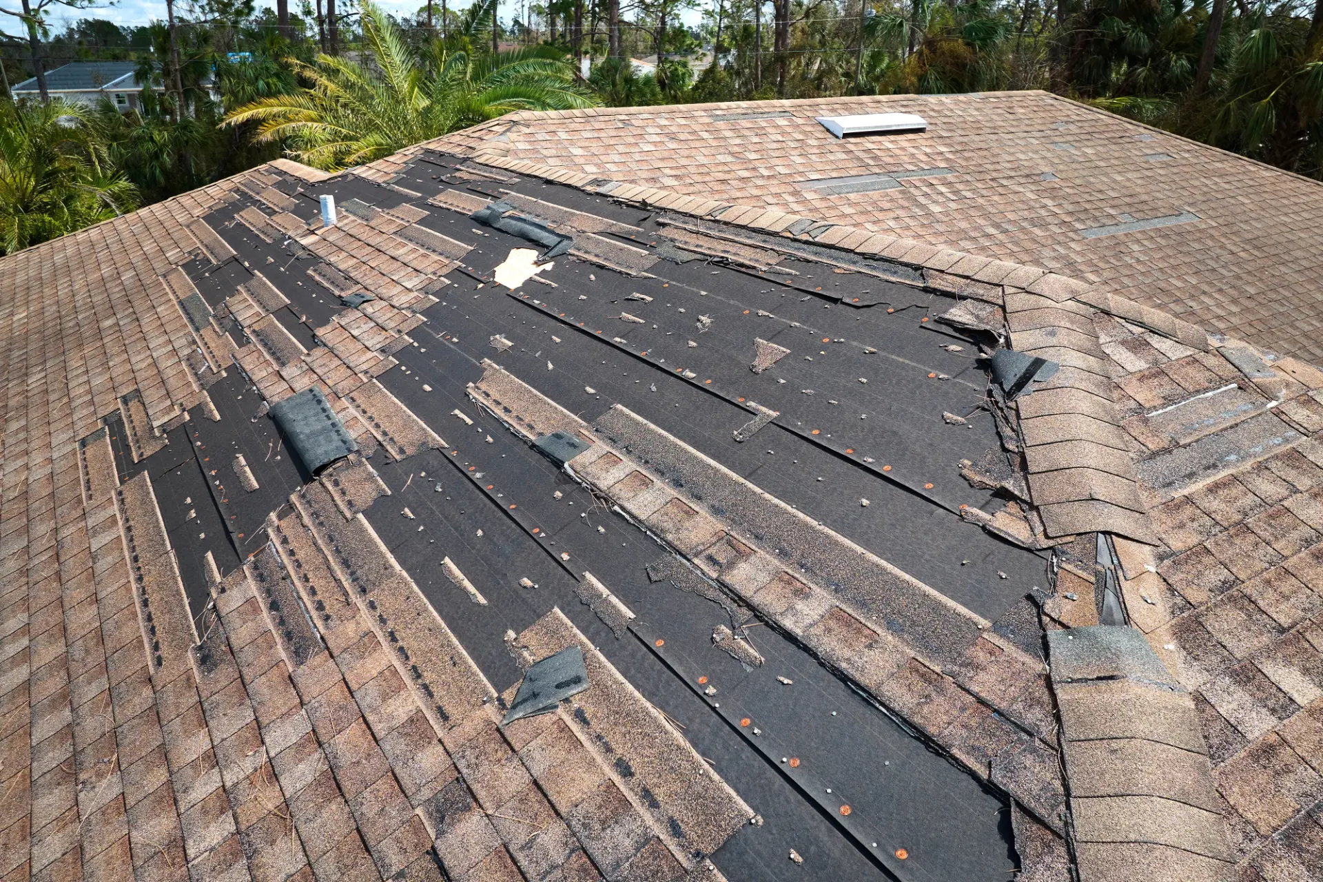 Storm-damaged roof with missing shingles